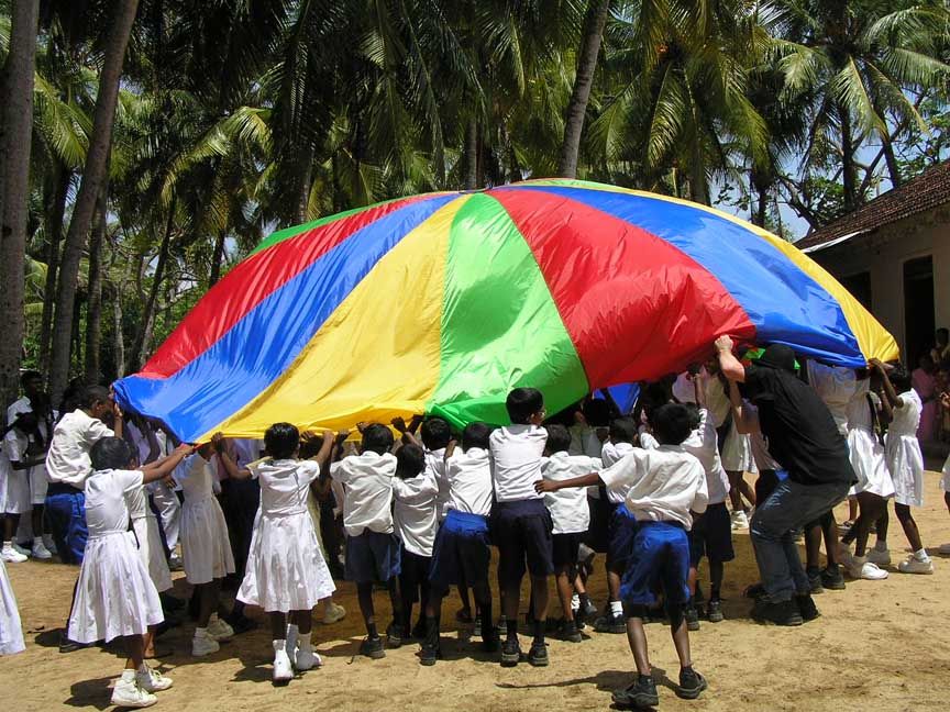 [ Children playing a parachute game. ]